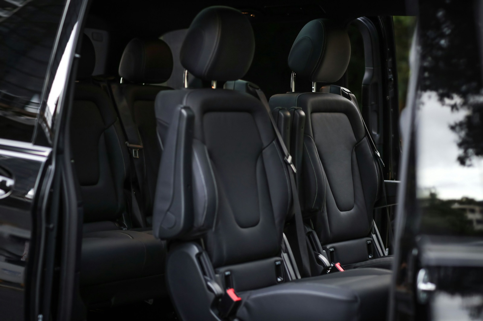 Leather captain seats inside a black VIP minibus