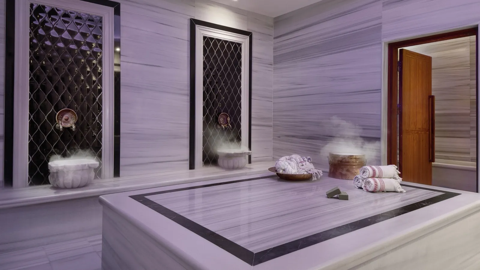 A marble hammam with a warm central stone